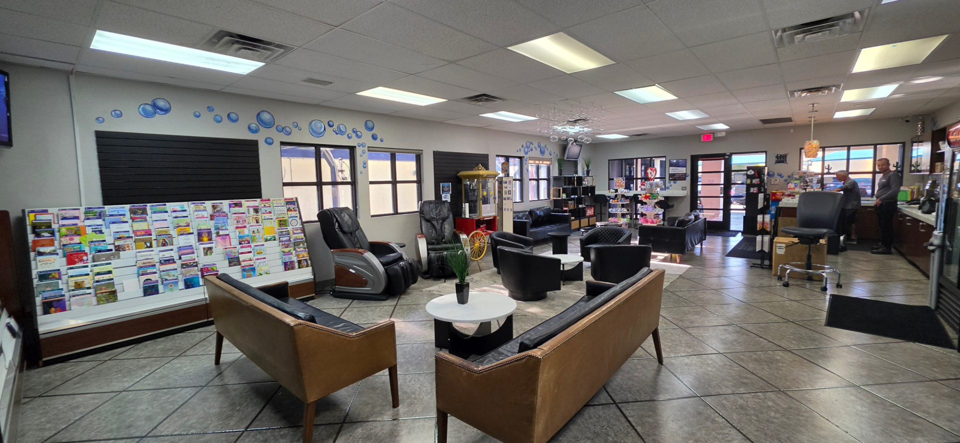 Lucky 7 Hand Car Wash customer lounge with sofas, massage chairs, and front counter