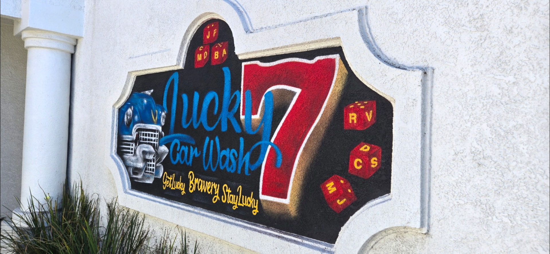 Lucky 7 mural featuring a classic car and dice